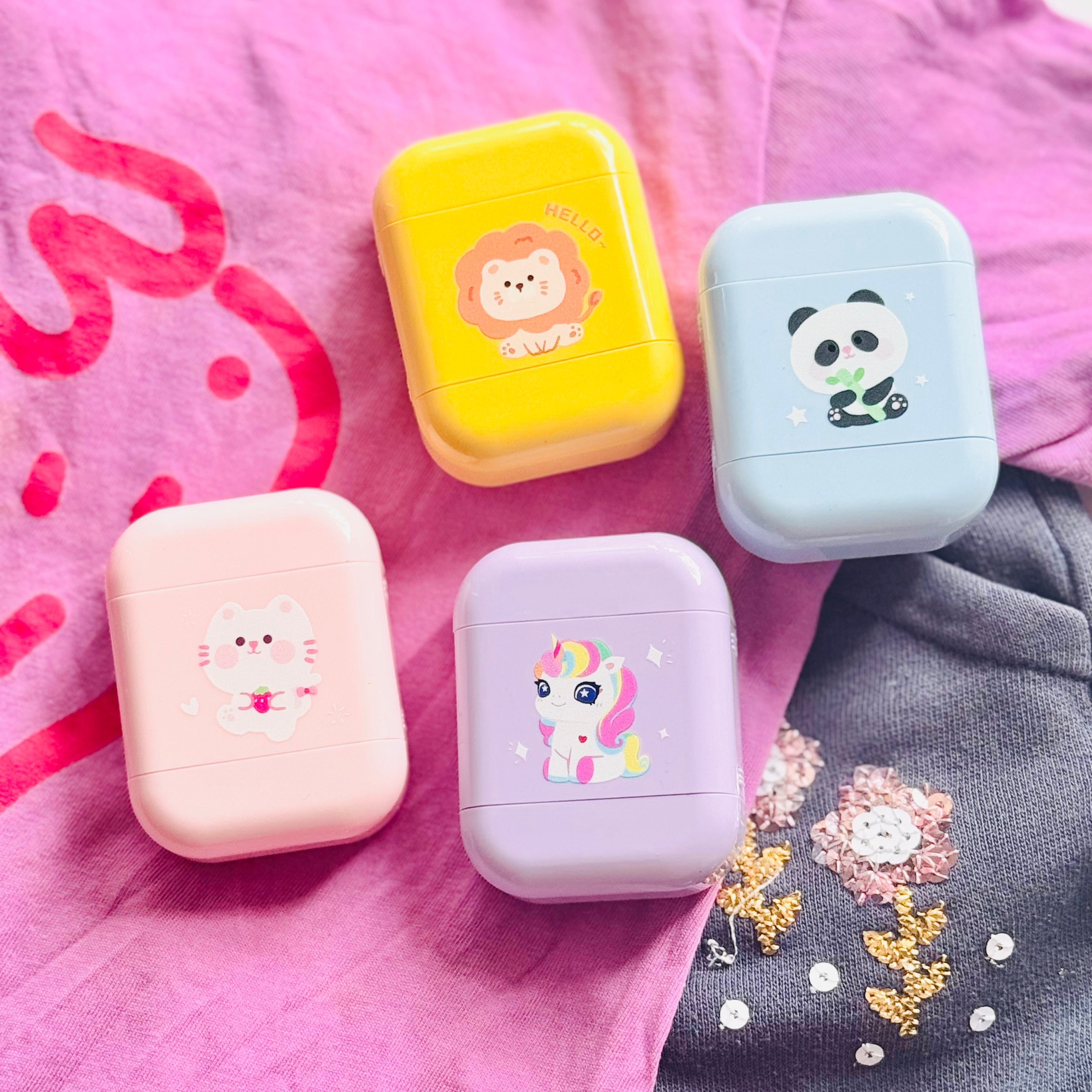 A set of four coloured name stamps