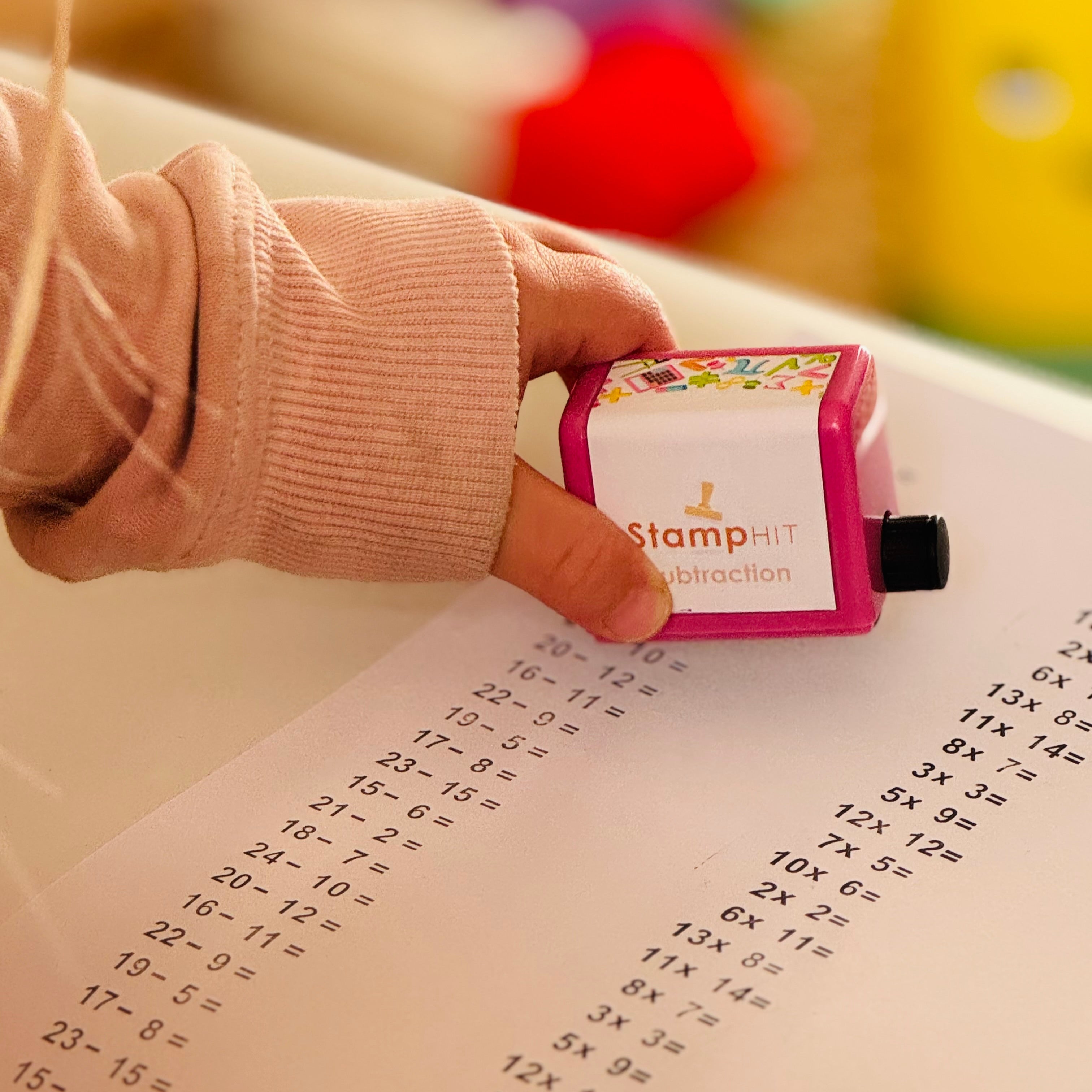 Little hand holding a math stamp