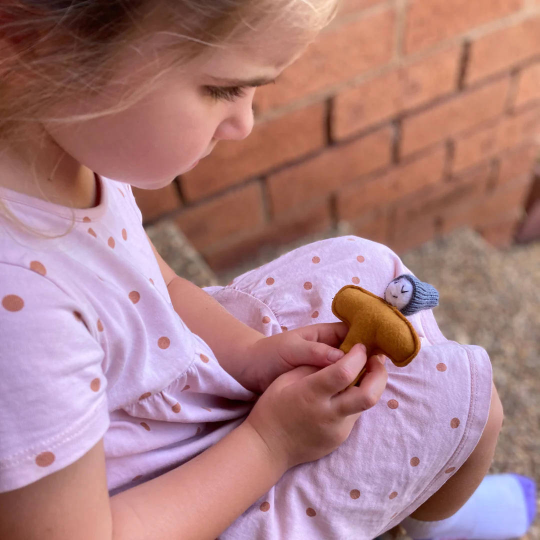A little girl cuddles a soft stamp toy
