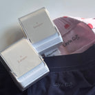 Two StampHIT name stamps laid out ion kids clothes
