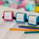 Three math stamps sitting on paper with pencils 