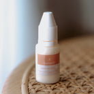 White fabric ink refill bottle sitting upright with the StampHIT logo on the front