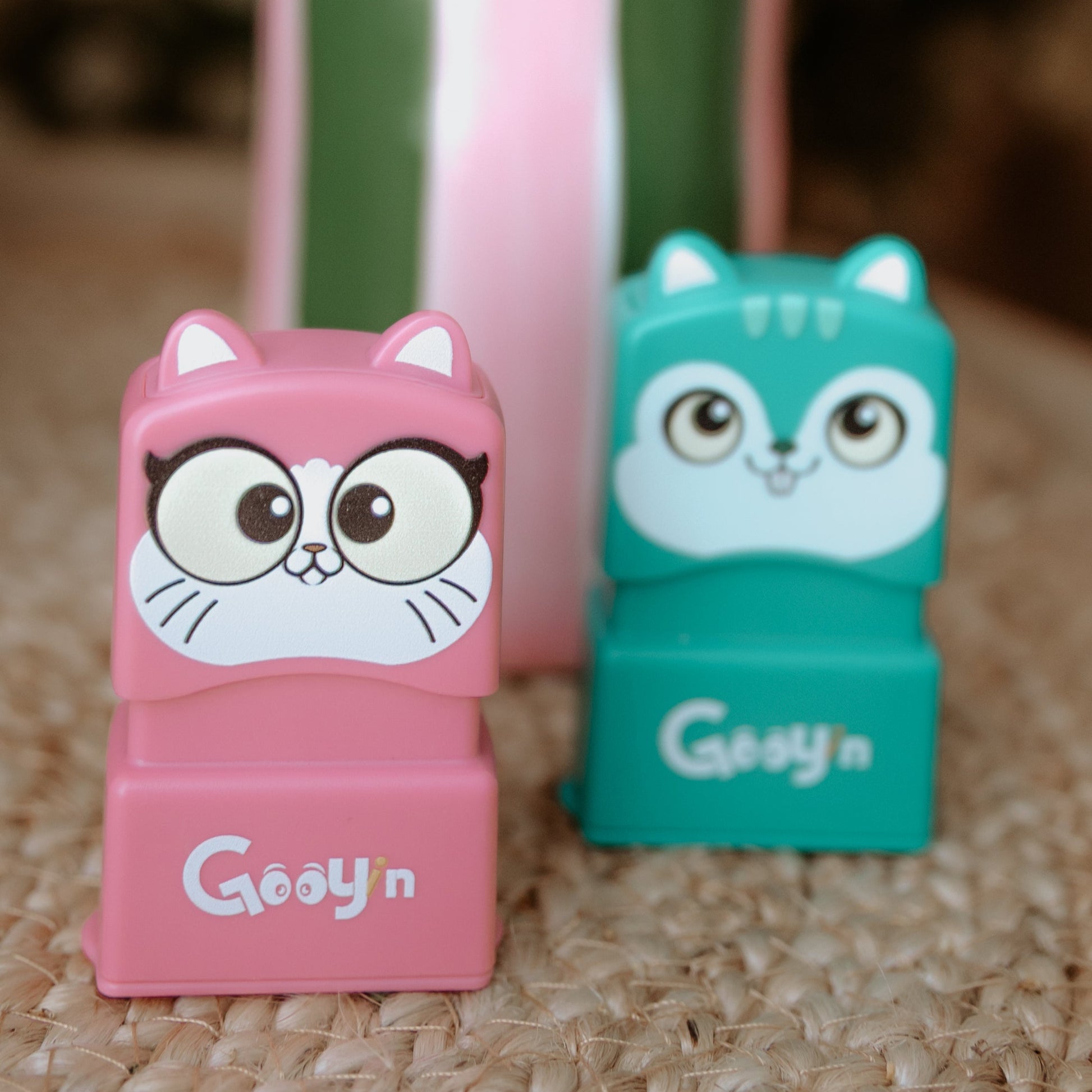 A cat and a mouse stamp sitting beside each other with 'Gooyin' printed on the front of both